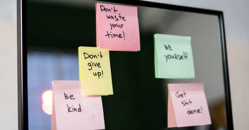 Colorful sticky notes with motivational messages on a mirror reflecting positivity.